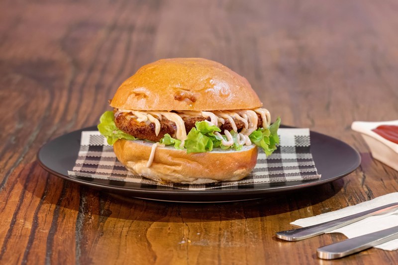 Den's Chicken Burger on a dark plate